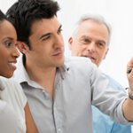 A business team collaborating and analyzing reports during an office meeting.