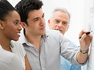 A business team collaborating and analyzing reports during an office meeting.